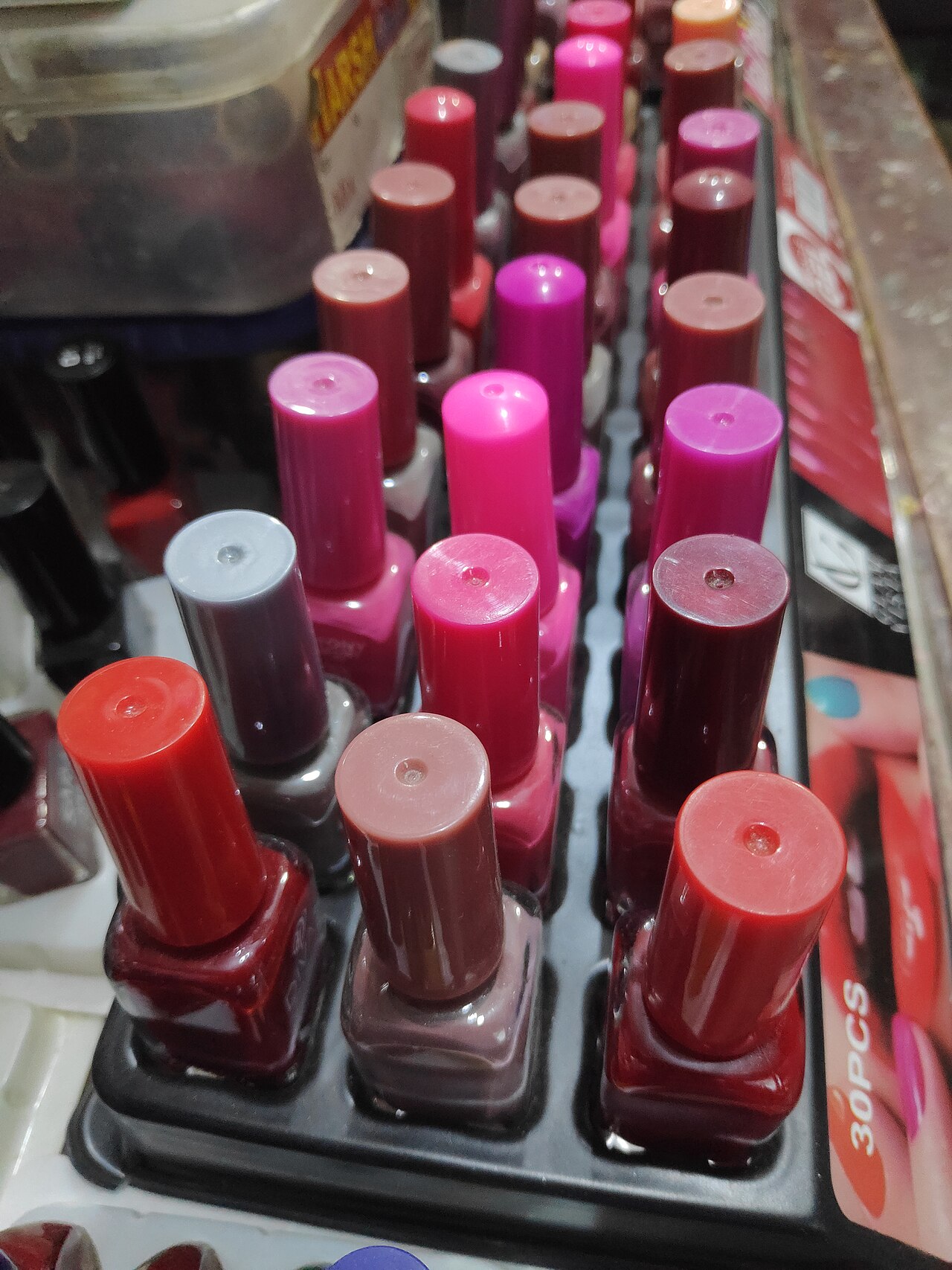 A bottle of nail polish with a brush